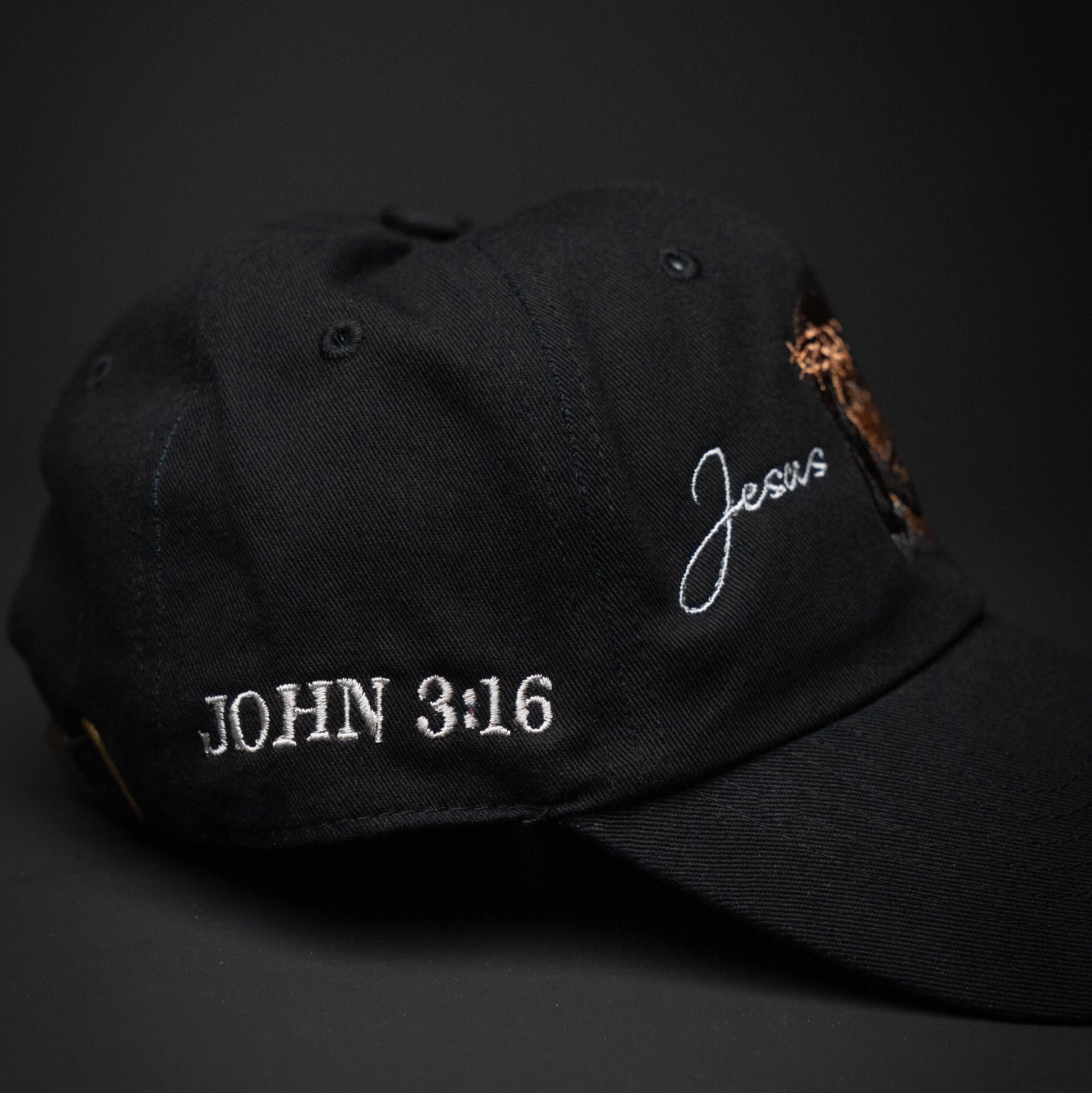 Black cap with 'John 3:16' and 'Jesus' embroidered on a dark background